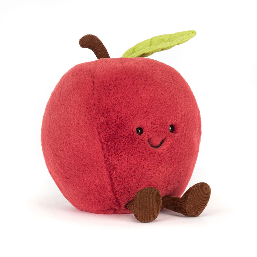 Plush toy apple with a smiling face on a white background