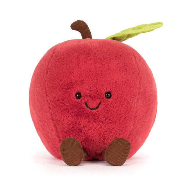 Plush toy shaped like a red apple with a smiling face on a white background